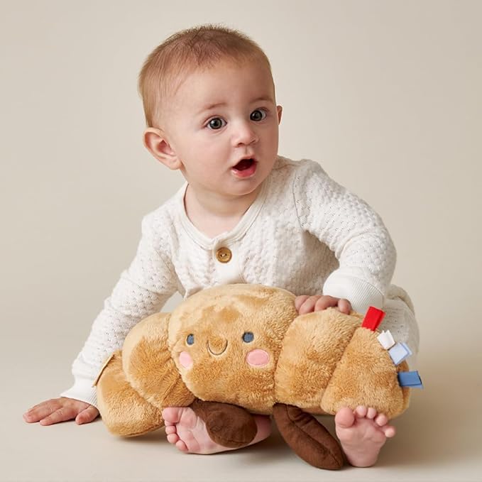 Itzy Ritzy Snuggles Plush Toy – Soft Stuffed Animal for Babies, Kids & Adults – Sensory Ribbons & Textured Fabrics for Tactile Play – Cozy & Cuddly Companion for Newborns & Up (Croissant)