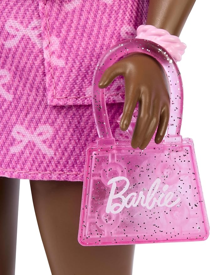 Barbie Deluxe Style Doll #10 in Pink Denim Top and Skirt Set with Bow Print, Black Hair, Behind-the-Ear Hearing Aids and Accessories Like Handbag