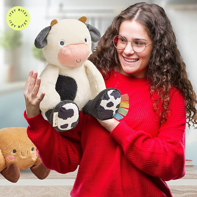 Itzy Ritzy Snuggles Plush Toy – Soft Stuffed Animal for Babies, Kids & Adults – Sensory Ribbons & Textured Fabrics for Tactile Play – Cozy & Cuddly Companion for Newborns & Up (Cow)